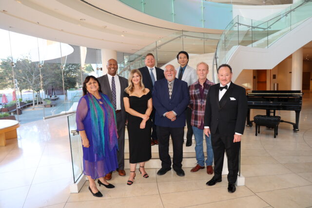 Guests pose by an indoor staircase