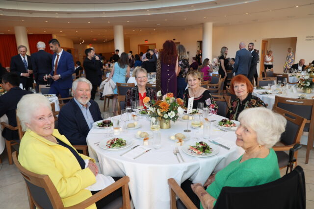 Guests at a circular dinner table at the OC Arts Awards