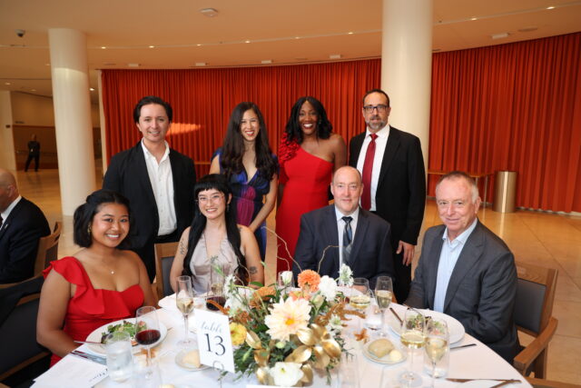 Guests at a circular dinner table at the OC Arts Awards