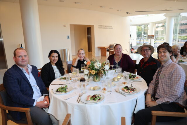 Guests at a circular dinner table at the OC Arts Awards