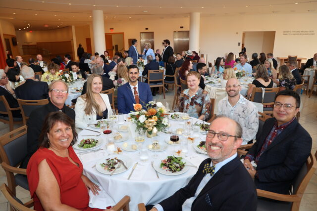 Guests at a circular dinner table at the OC Arts Awards