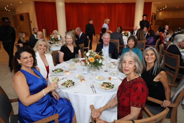Guests at a circular dinner table at the OC Arts Awards