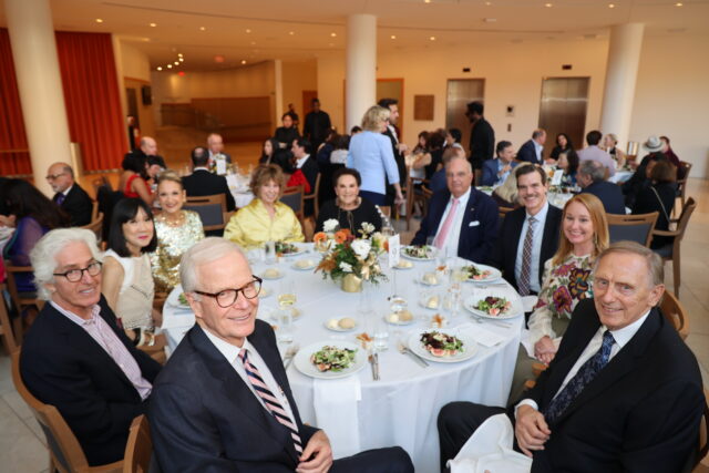 Guests at a circular dinner table at the OC Arts Awards
