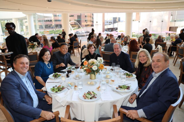 Guests at a circular dinner table at the OC Arts Awards