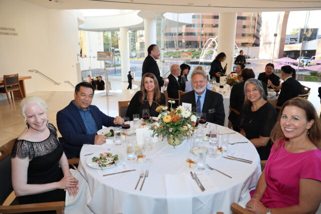 Guests at a circular dinner table at the OC Arts Awards