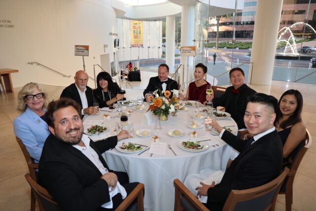 Guests at a circular dinner table at the OC Arts Awards