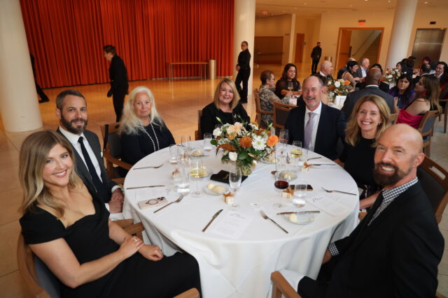 Guests at a circular dinner table at the OC Arts Awards