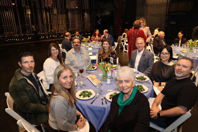 Guests sit around a circular table at a luncheon