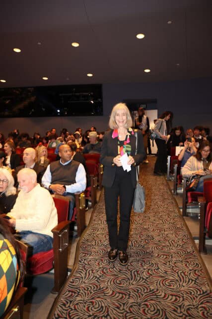 A woman in the aisle of a theatre