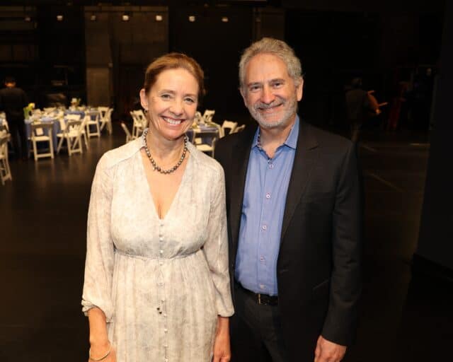 A woman and a man smile for the camera