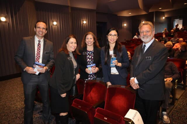 Five guests stand on the floor of the Barclay Theatre